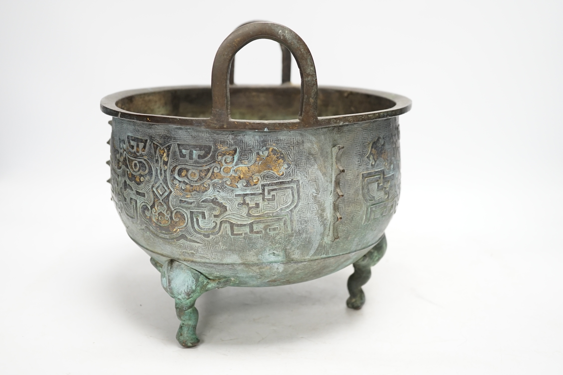 A large Chinese parcel gilt bronze tripod censer, 24.5cm high, 25cm diameter. Condition - fair